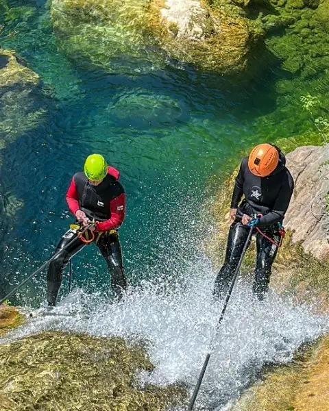 Two guests descending above turquoise water