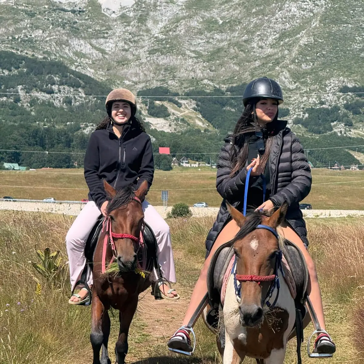 Guests horse riding beneath Montenegro's mountain peaks