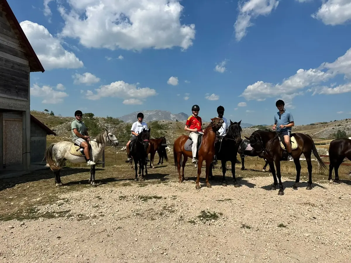 Riders gathered with their horses at a mountain farm near Žabljak