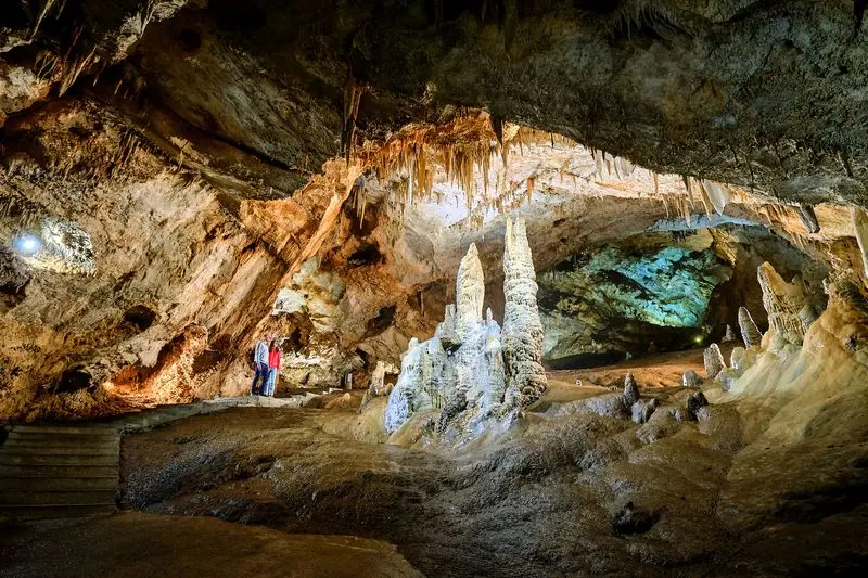 Natural cave formations illuminated along the visitor route