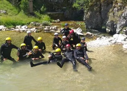 Canyoning group resting in mountain water