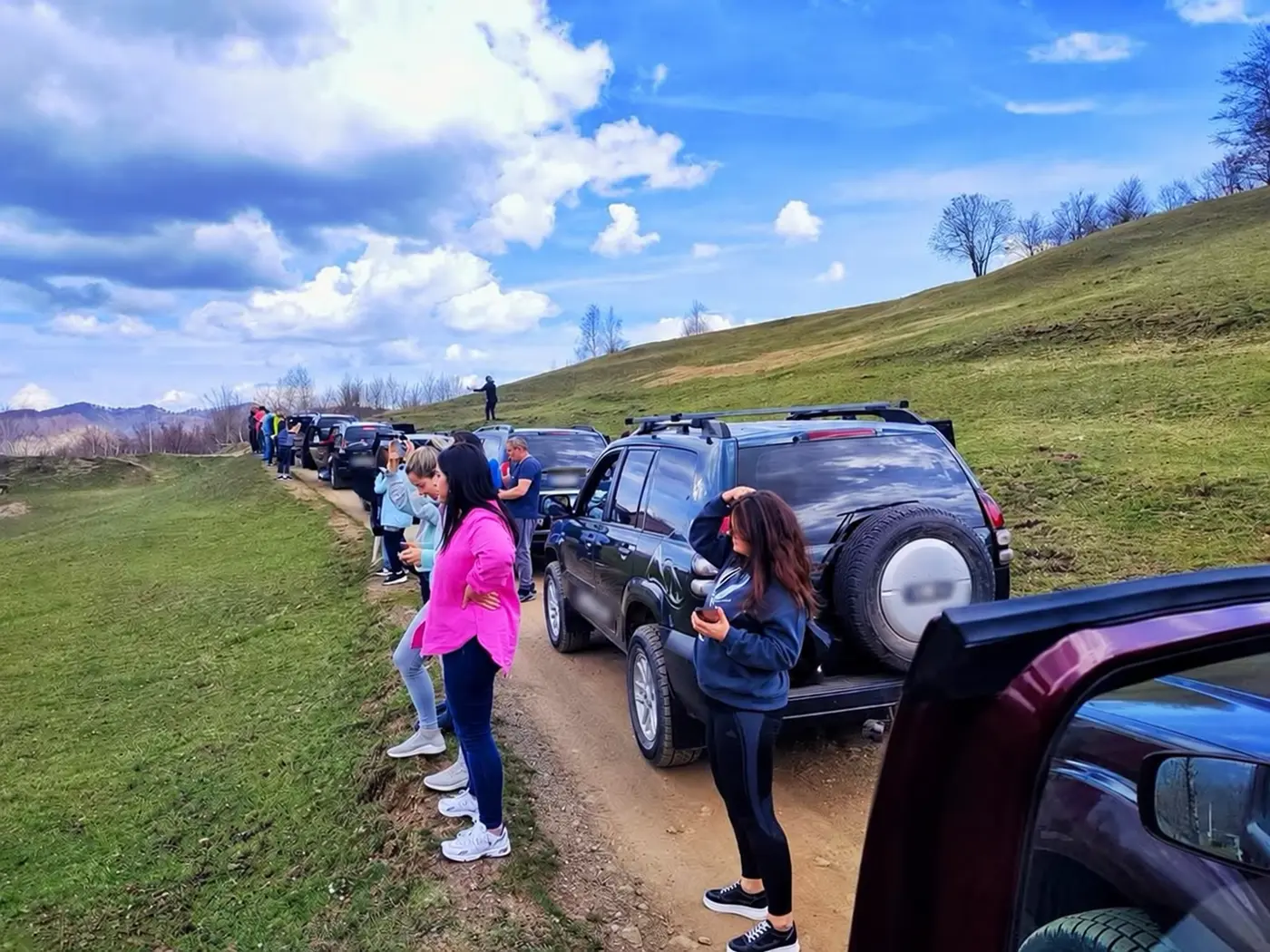 Guests taking a scenic break beside a Jeep convoy on Bjelasica