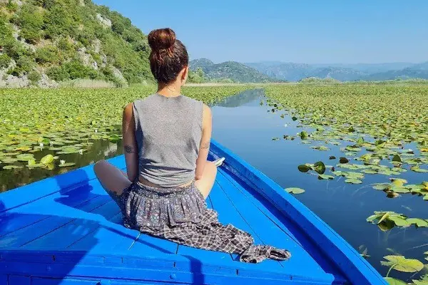 Boat travelling through water lilies on Skadar Lake