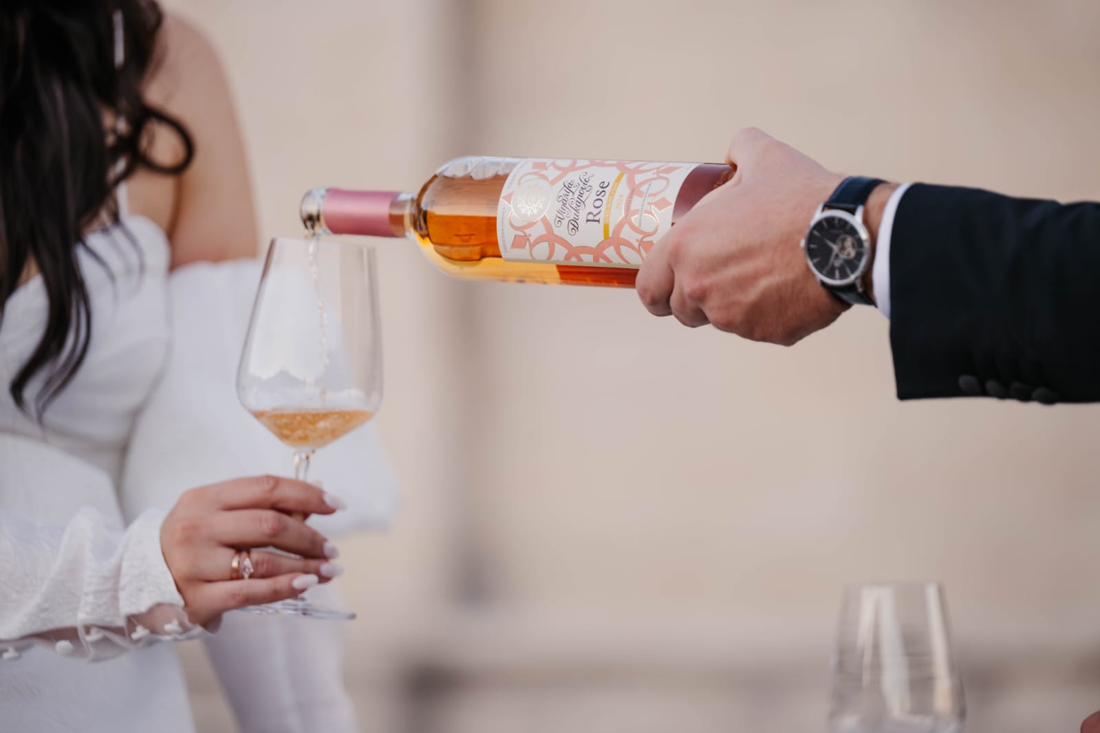 Rosé wine being poured during a vineyard tasting